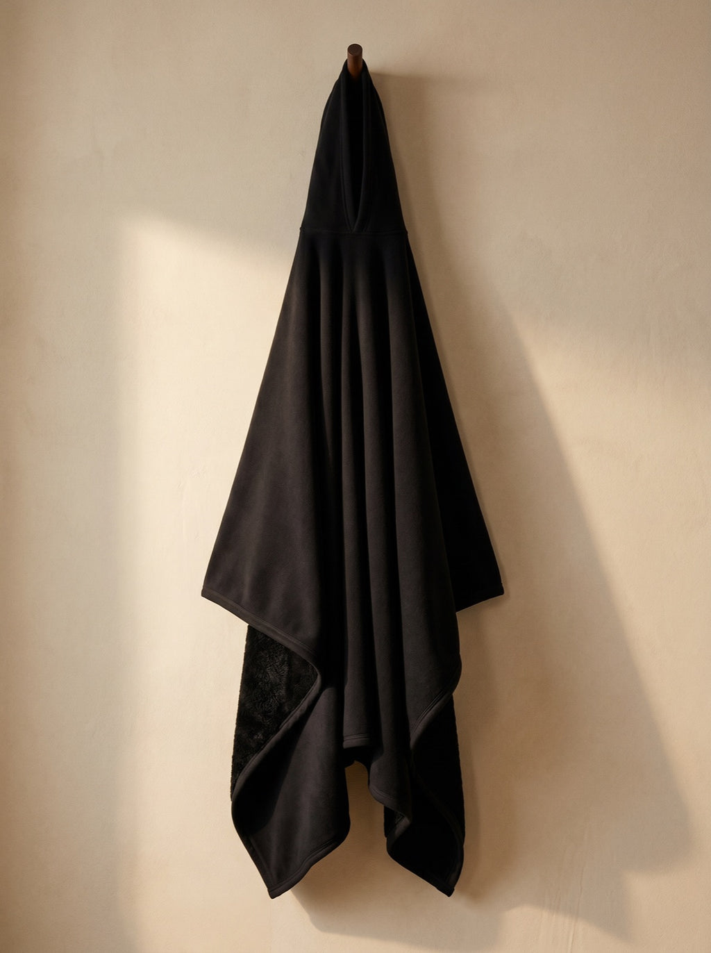 Obsidian — The Exhale, hung, corner folded back to show the deep-pile sherpa interior