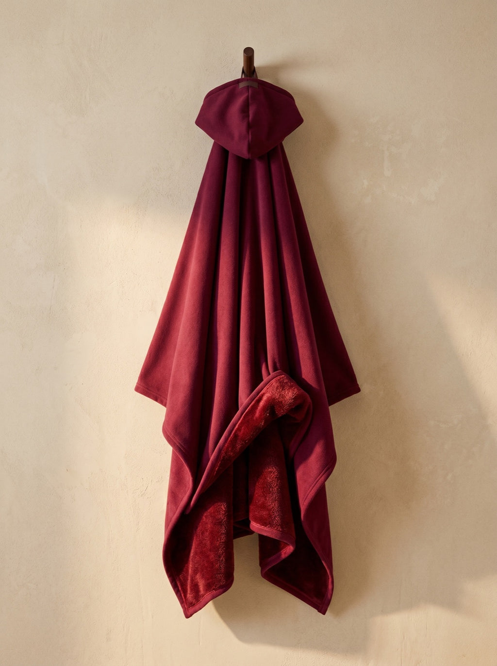 Wine — The Exhale, hung, corner folded back to show the deep-pile sherpa interior