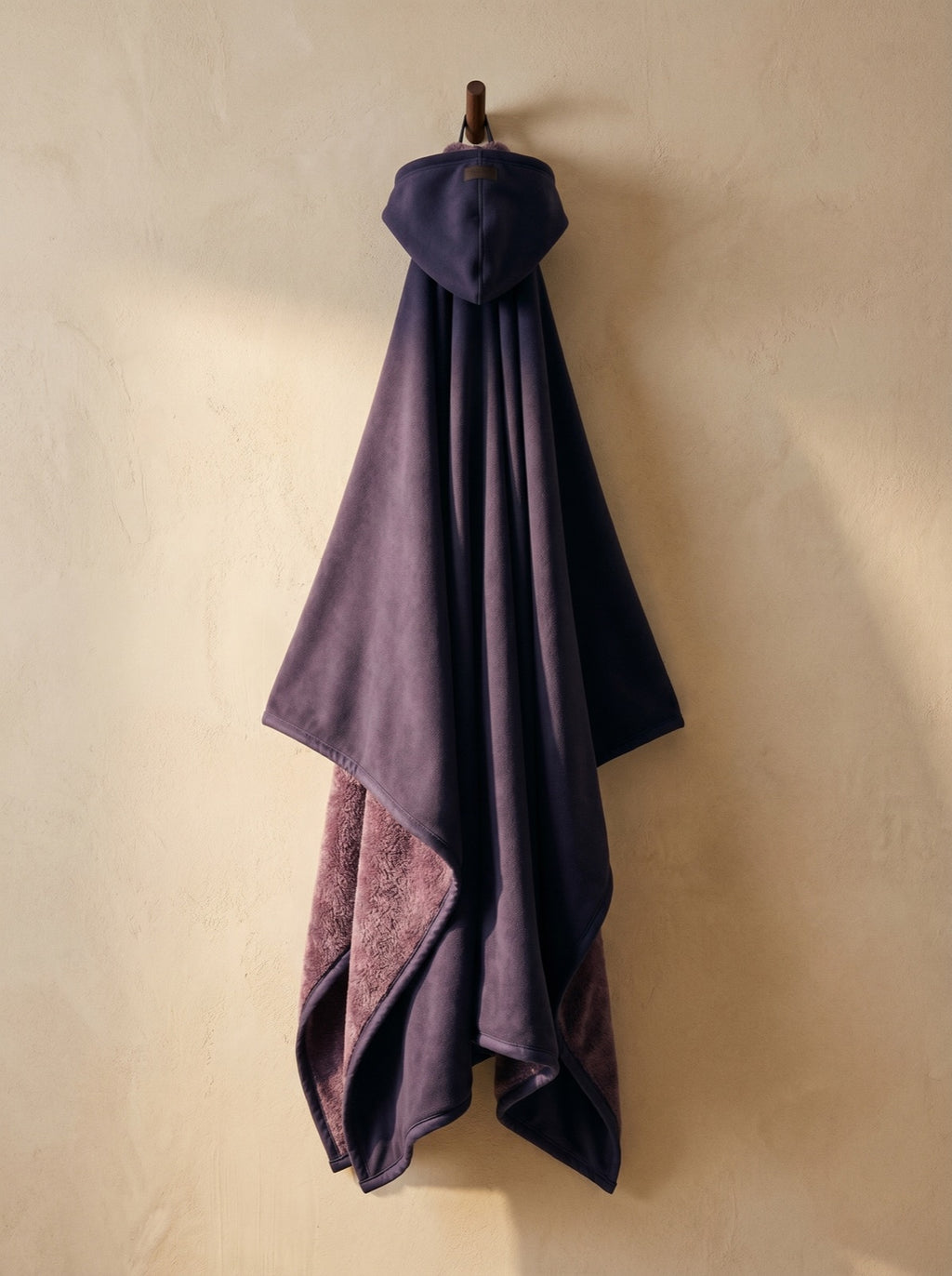 Arcane — The Exhale, hung, corner folded back to show the deep-pile sherpa interior