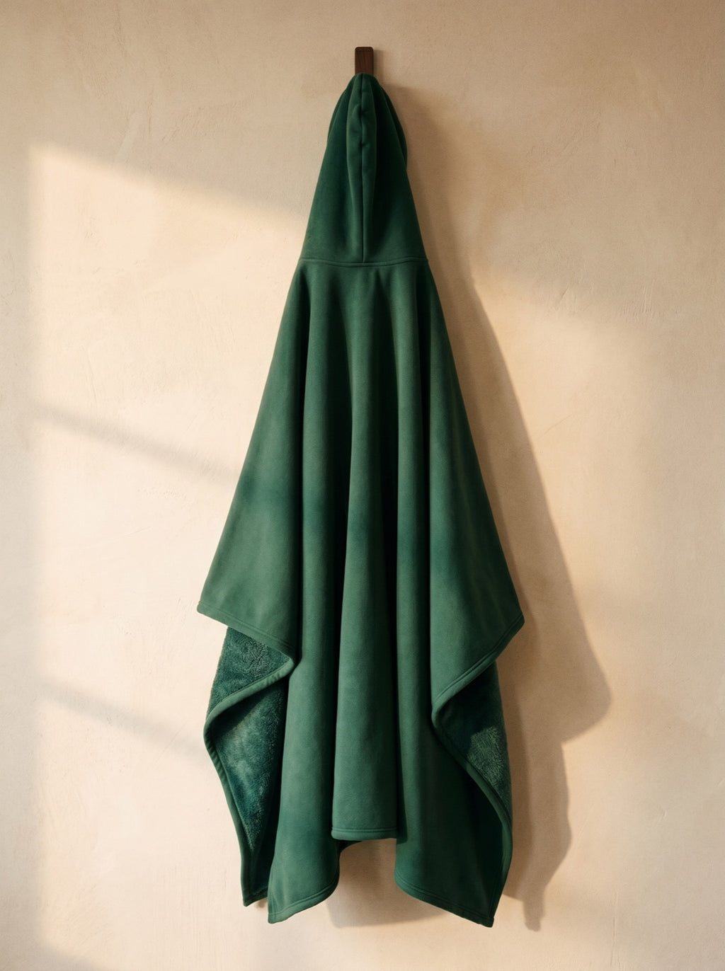 Willow — The Exhale, hung, corner folded back to show the deep-pile sherpa interior